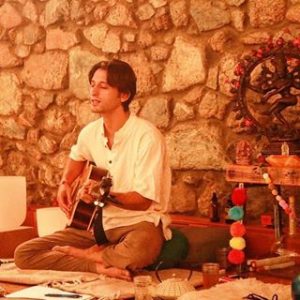Darin playing guitar at cacao ceremony