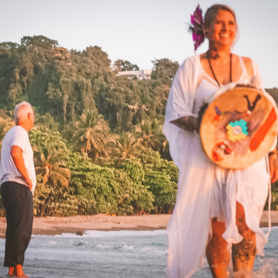 Colynn with drum on beach jungle