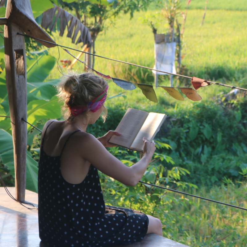Woman reads book in Guatemala at a 200 hour yoga teacher training retreat Woman reads book in Guatemala at a 200 hour yoga teacher training retreat